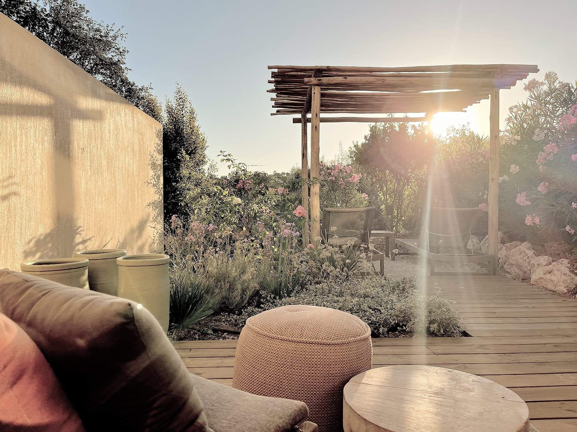 Toile Blanche — the pergola and terrace at sunset